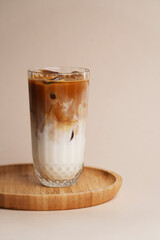 Iced coffee cocktail glass on pastel background