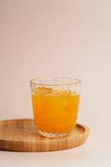 Glass of orange juice with ice on white background