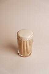 Glass of Cappuccino coffee with rose flower buds