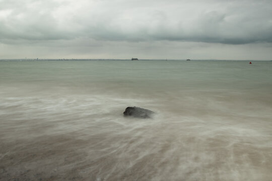 long exposure shot of rocks in the calm sea