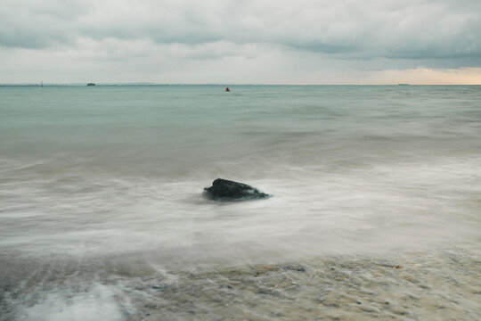 long exposure shot of rocks in the calm sea