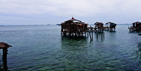houses damaged by waves with sea and sky in the background