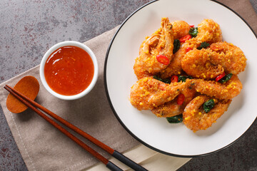 Asian style fried shrimp with salted egg yolks, curry leaves and chili served with chili sauce...