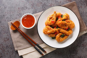 Crispy delicious fried shrimp with salted egg yolks, curry leaves and chili peppers served with...