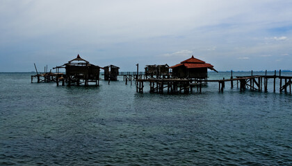 houses damaged by waves with sea and sky in the background