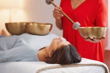 Woman having a Tibetan sound bowl massage