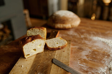 Sliced healthy wheat bread loaf on kitchen wooden board