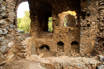 Ancient town with round shape broken walls on sunset 