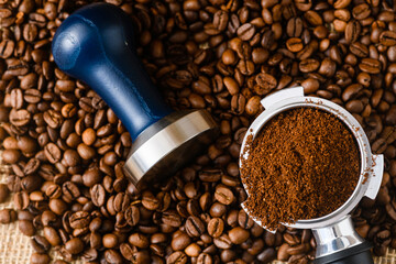 Ground coffee with tamper, holder and beans