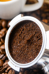 Spent or used coffee grounds with holder and a cup of freshly brewed coffee