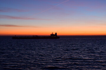 ship on horizon in the dark sunset