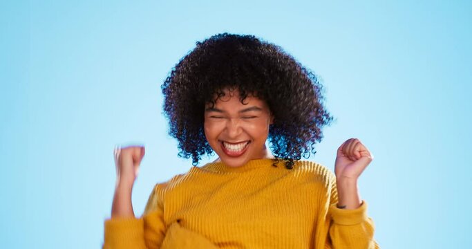 Yes, winning and happy woman isolated on blue background dancing, celebration and excited fist pump. Wow, winner and dance of biracial person celebrate prize, competition or promotion news in studio