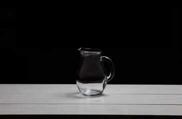Glass water jug on table. Space for text, for advertising, menu and printed materials
