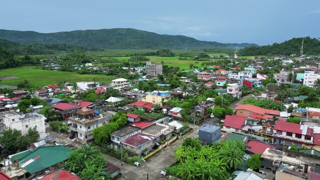 Establishing, Aerial View of Quaint Barangay Village with island meadows and mountains in background. Bato, Catanduanes.