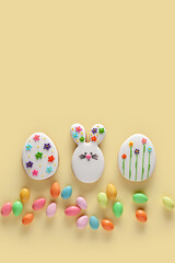 Happy Easter. Colorful Easter cookies on the yellow background. 