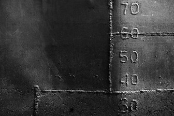 Grungy old ship hull with weld seams and draft marks