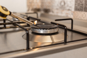 girl lights up the stove with a lighter