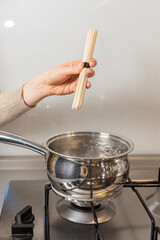 A girl is cooking udon.