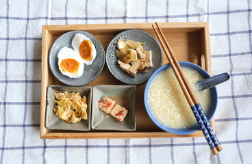 Typical Chinese breakfast and lunch. Millet Porridge with Fermented Beancurd, Pan-fried Char Choy(Pickled Mustard Root) Dried Shrimps Beancurd, Scrambled Egg Fries Silverfish and Salted Duck Egg