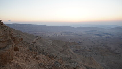Fototapeta na wymiar Sunrise view of HaMakhtesh HaGadol the big crater, in the Negev Desert, Southern Israel. It is a geological landform of a large erosion cirque