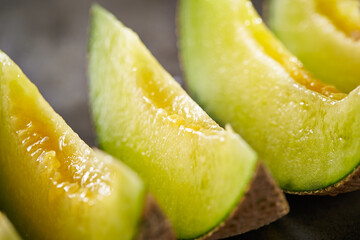 slices of melon on a dark background