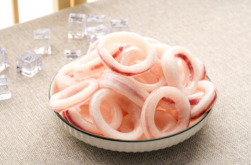 Frozen squid rings on a simple background