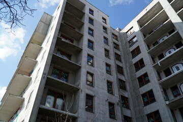 Abandoned, unfinished residential building covered with graffiti - view from below