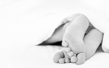 Children's bare feet. Black and white photo. Banner