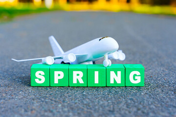 Season Change: Toy Plane and Letters Spelling SPRING