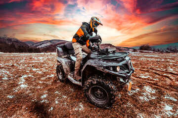 A man drives an ATV in the mud. Drift driving an ATV quad in mud and snow © Minet