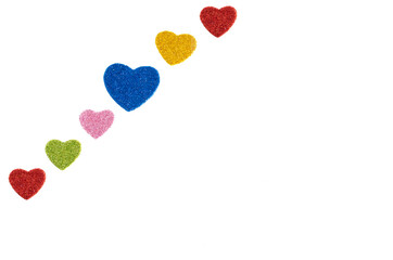 background of colored hearts, six colored hearts with glitter, perpendicular, one blue heart bigger...