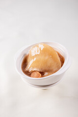 hot braised premium shark's fin soup and crab meat scallop in convoy superior stock white bowl on red cloth background chinese seafood banquet halal menu