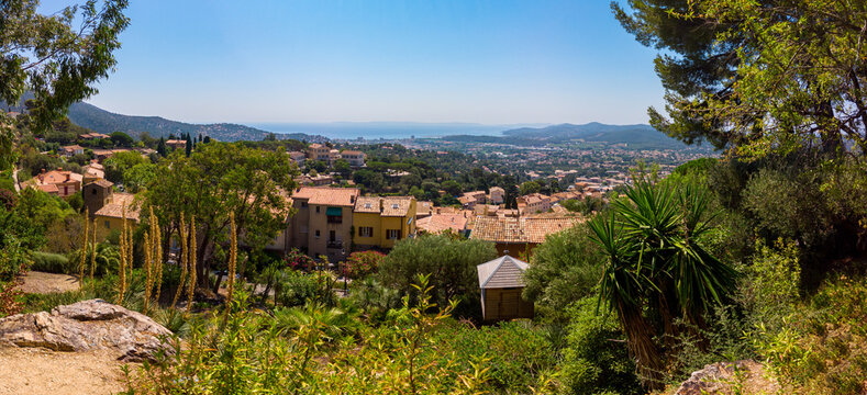 A stunning panoramic view from Bormes les Mimosas at the Mediterranean Sea, with a beautiful environment of buildings and trees. © fotografiemahieu