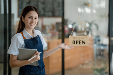 Startup successful small business owner sme beauty girl stand with tablet in coffee shop restaurant, asian tan woman barista cafe owner, entrepreneur seller business concept