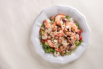 chilled cold big prawn salad with mixed fresh fruit in sesame sauce and garlic nuts on wood table chinese asian halal banquet seafood menu
