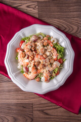 chilled cold big prawn salad with mixed fresh fruit in sesame sauce and garlic nuts on wood table chinese asian halal banquet seafood menu