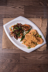 two in one varieties wok fried big prawn with nonya sweet and sour dark sauce and cereal butter prawn with curry leaf on wood table chinese halal banquet seafood menu