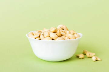 cashew nuts in wooden bowl on table background. top view. Space for text Healthy food