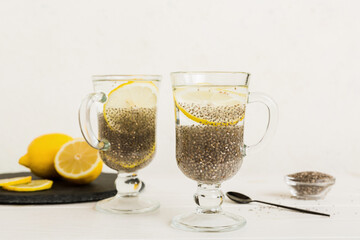 Healthy breakfast or morning with chia seeds and lemon on table background, vegetarian food, diet and health concept. Chia pudding with lemon