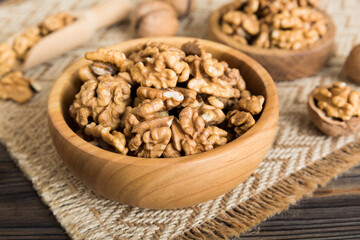 Fototapeta premium Fresh healthy walnuts in bowl on colored table background. Top view Healthy eating bertholletia concept. Super foods