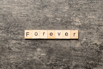 forever word written on wood block. forever text on table, concept