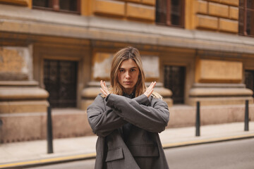 Woman arms crossed at her chest demonstrates Break The Bias symbol of international women's day...