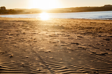 sunset on the beach sand close up