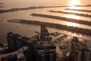 Palm Jumeirah island in Dubai on sunset, modern architecture, beaches and villas