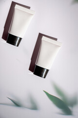 cosmetic product in tube, bottle, lotion or serum on white background.