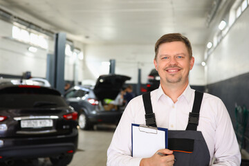 Portrait of confident male mechanic in workshop