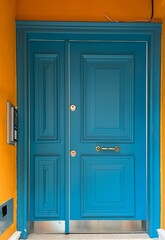 Blue wooden door in a orange wall