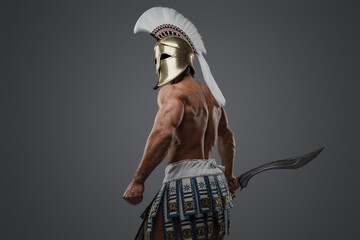 Shot of isolated on gray background muscular warrior from antique greece.