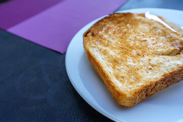 Toast in a white plate on the table