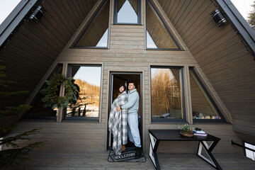 Couple in love on terrace off grid tiny house in the mountains.